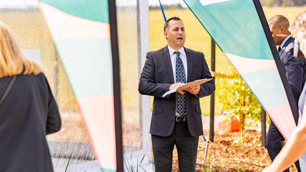 Male real estate agent running an auction for land sales